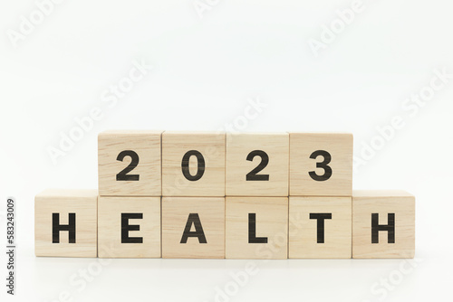 Wooden cubes 2023 with text "HEALTH" on white background and copy space. Health management and trend concept in 2023. Medical healthcare business and personal healthcare.