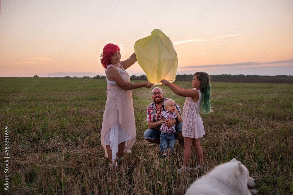 Diversity Family With Samoyed Dog Launch Yellow Sky Lantern In Field At Sunset Teamwork Stock Diversity Family With Samoyed Dog Launch Yellow Sky Lantern In Field At Sunset Teamwork Stock