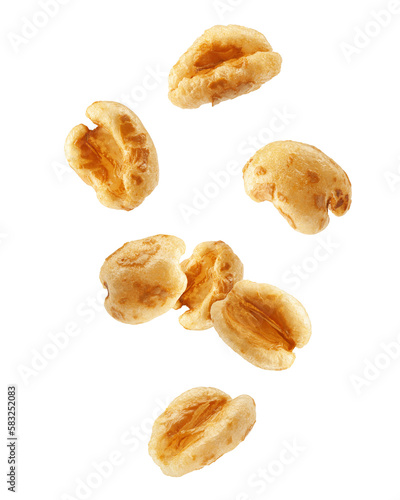 Falling puffed Wheat cereal, isolated on white background, full depth of field