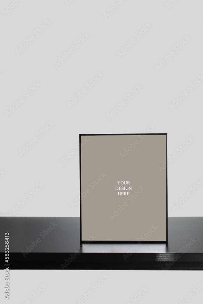 Vertical Frame Mockup on Black Wooden Desk with Natural Shadows Vertical Frame Mockup on Black Wooden Desk with Natural Shadows