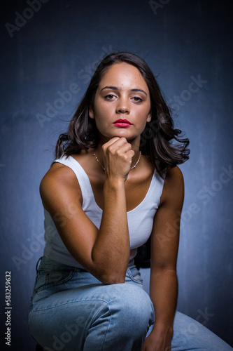 Close up image of a Dark Haired Girl Posing for a Fashion Shoot in a studio