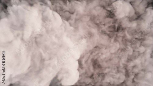 Thick smoke pouring into the frame. 4K background clip.