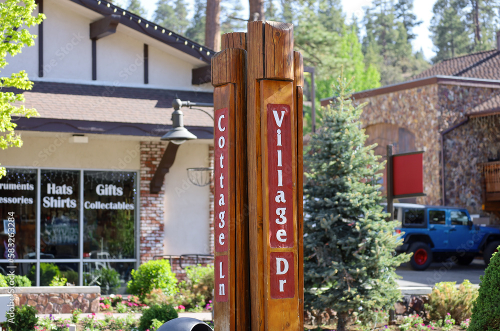 Naklejka premium The Village Mall street wooden signs at Big Bear Lake in southern California.