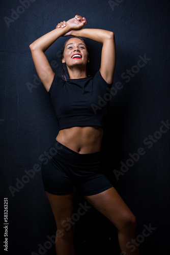 Close up image of a Dark Haired Girl Posing for a Fitness Photo shoot © Dewald