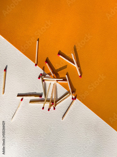 Scattered matches on a yellow and white background