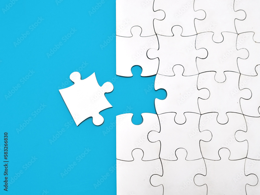 White jigsaw puzzle on blue background, top angle view White jigsaw puzzle on blue background, top angle view