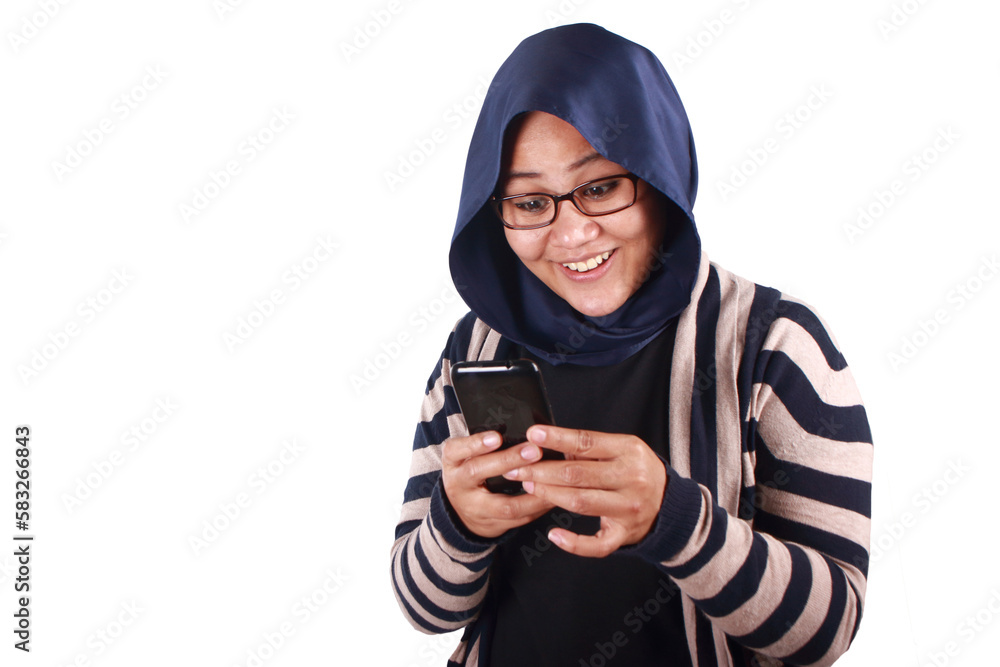 Portrait of young Asian muslim woman wearing hijab get good news on her phone, happy surprised Portrait of young Asian muslim woman wearing hijab get good news on her phone, happy surprised