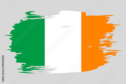 Flag of Ireland painted with a brush stroke. Abstract concept. National flag in grunge style. Vector illustration photo
