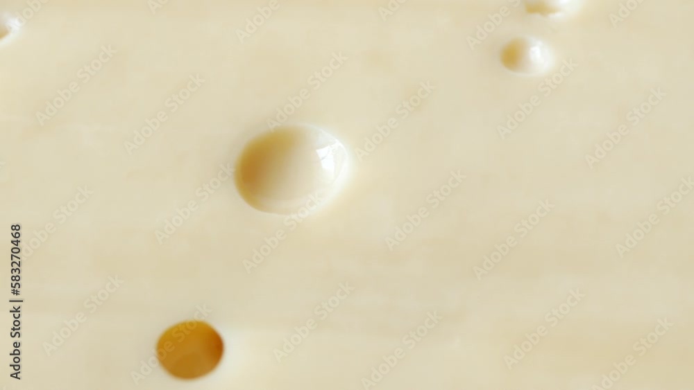 sliced cheese with holes on a chopping board on table sliced cheese with holes on a chopping board on table