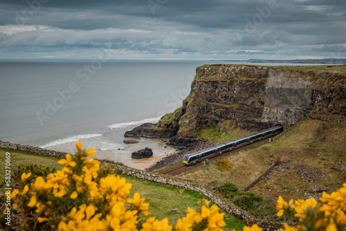 Beautiful stretch of North ireland rail between two tunnels and beach in downhill demesne close to castlerock. photo