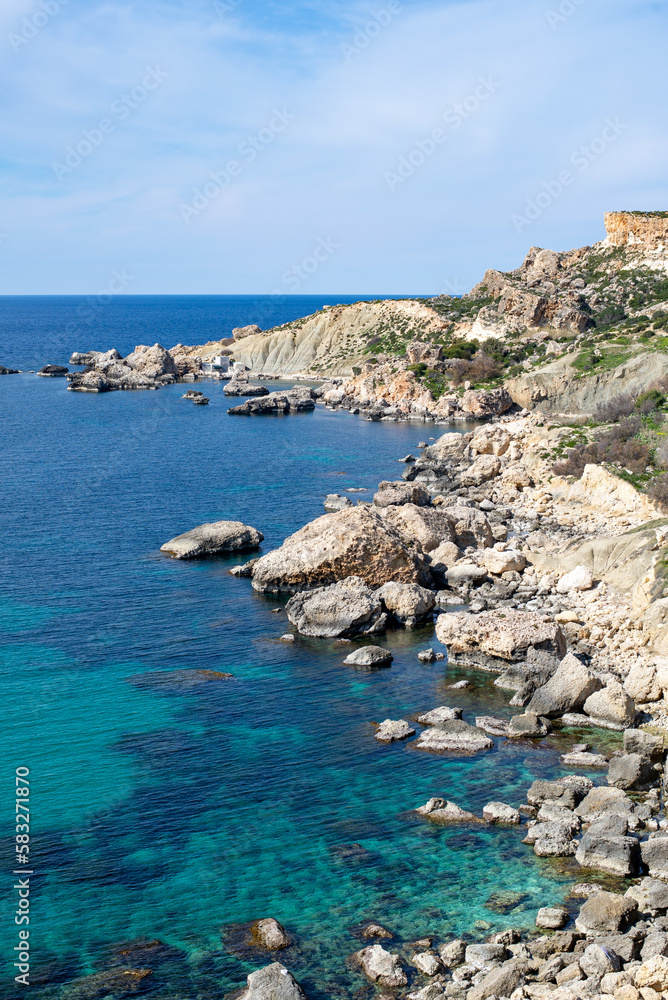 Breathtaking view of the picturesque Maltese coastline, where the crystal-clear waters of the Mediterranean Sea meet the stunning rocky cliffs, under the warm and vibrant Maltese sun