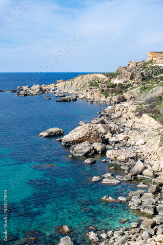 Breathtaking view of the picturesque Maltese coastline, where the crystal-clear waters of the Mediterranean Sea meet the stunning rocky cliffs, under the warm and vibrant Maltese sun