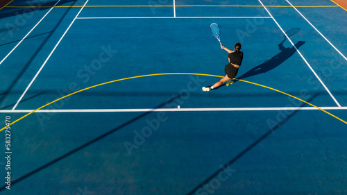 Drone Shot of Young Female Tennis Player on a New Court