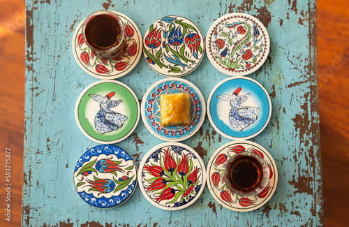 Photograph of Turkish Baklava in Ottoman Tile Turkish Coffee Cup and Turkish Tea Concept, Uskudar Istanbul, Turkey	 photo