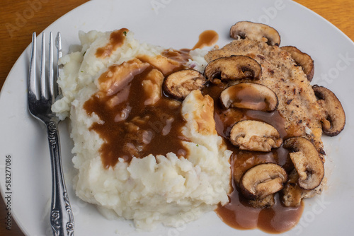 baked chicken breast top with  mushrooms and gravy