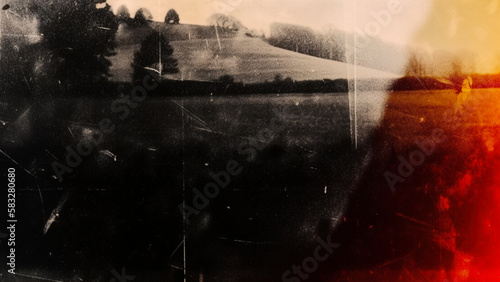 Background of an old analog camera film with noise and overexposure and elements of old photos. Made in nostalgic dark colors. photo