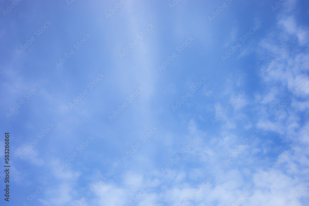 Blue sky background and white clouds soft focus, and copy space horizontal shape.