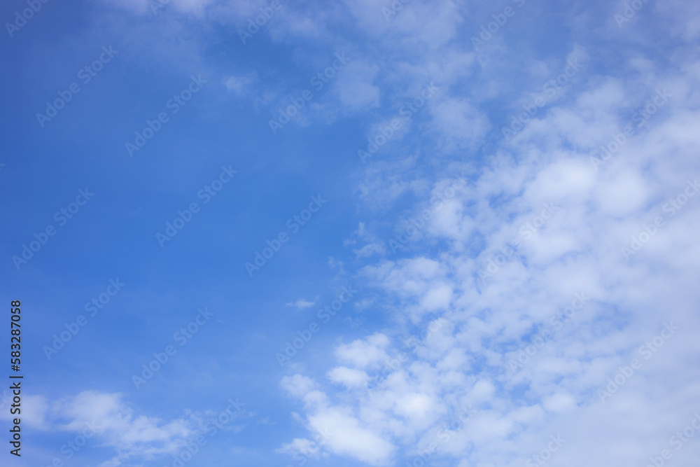 Naklejka premium Blue sky background and white clouds soft focus, and copy space horizontal shape.