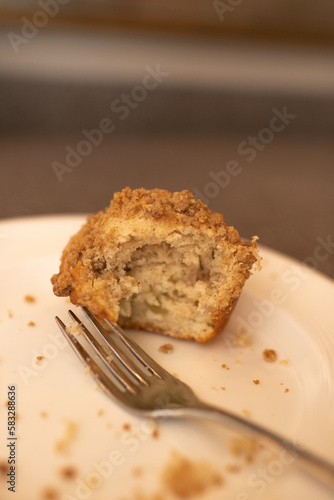 Half Eaten Banana Nut Muffin on Plate with a Fork and Crumbs 