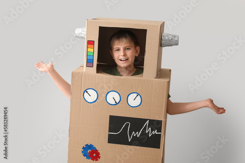 Little boy in cardboard rob...