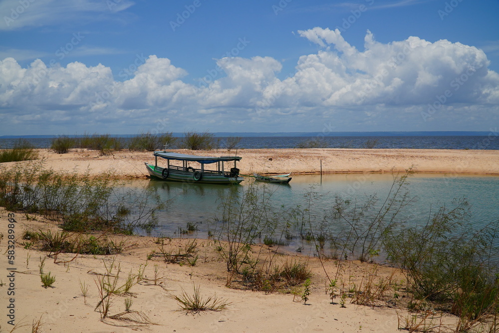 Idyllic tropical Amazon, paradise with the sandy river beach and the crystal clear waters of the Rio Tapajos, near the village of Pedra Branca,  state of Para, Brazil.