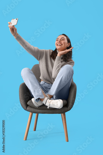 Young woman taking selfie i...