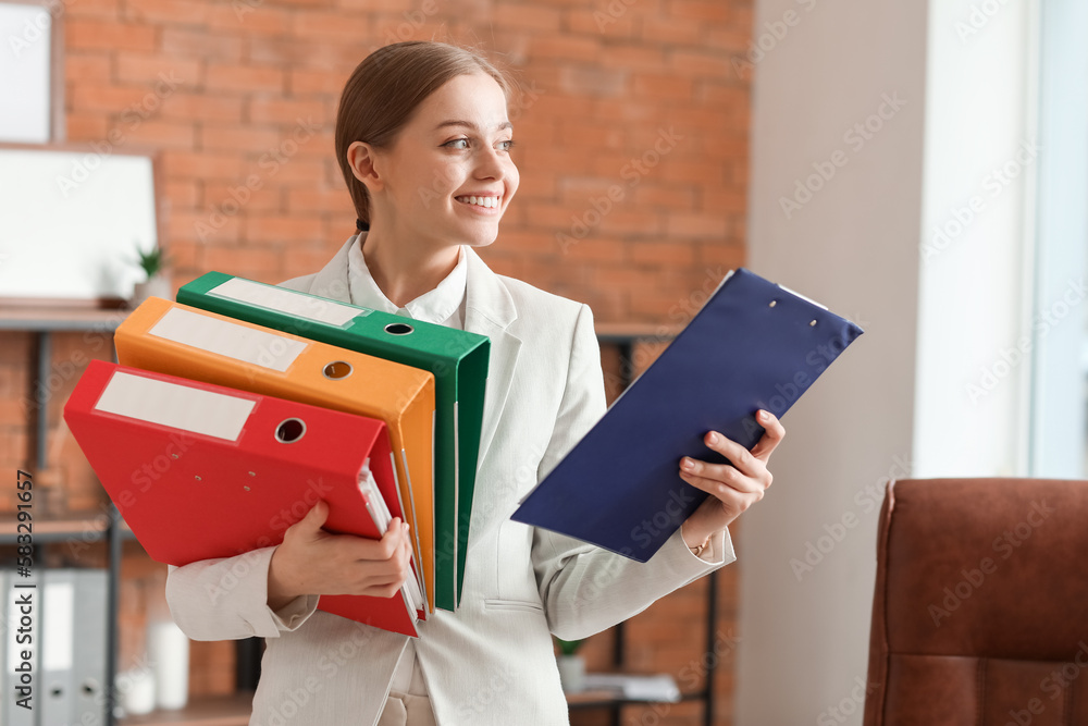 Female accountant with folders and clipboard in office Female accountant with folders and clipboard in office
