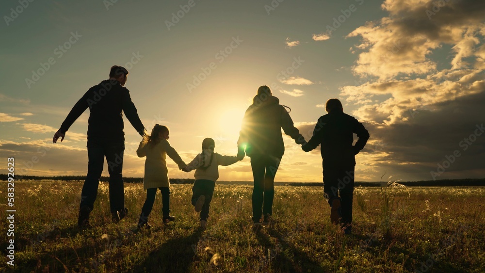 Happy family team, children, parents, run together in sun in park on grass. Concept Family game father mother daughter son fun running. Children's dream, mom dad little children, holiday in nature.