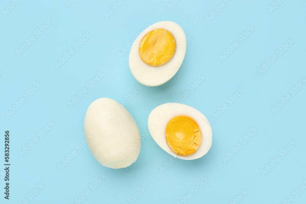 Delicious boiled eggs on blue background Delicious boiled eggs on blue background