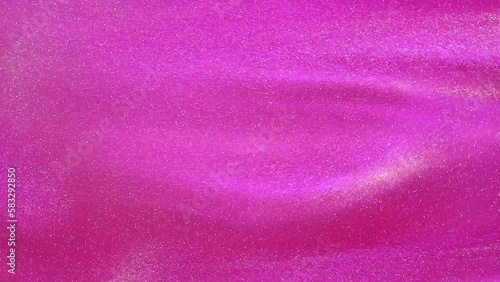 Silvery dust particles floating in a pink fluid. Overflows of luminous particles in a pink liquid. Abstract moving background of magic galaxy theme.
