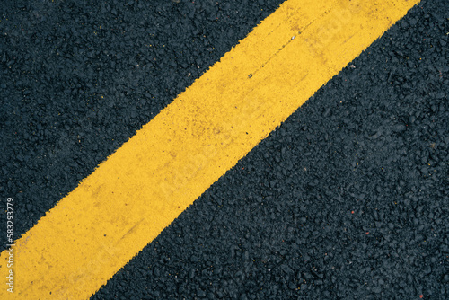 A close-up of a yellow lane on an asphalt road. © AddMeshCube