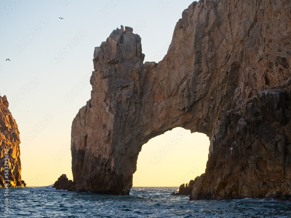 The sun sets on the Pacific side of Cabo San Lucas, with the glow making almost a silhouette out of the Arch of Cabo San Lucas