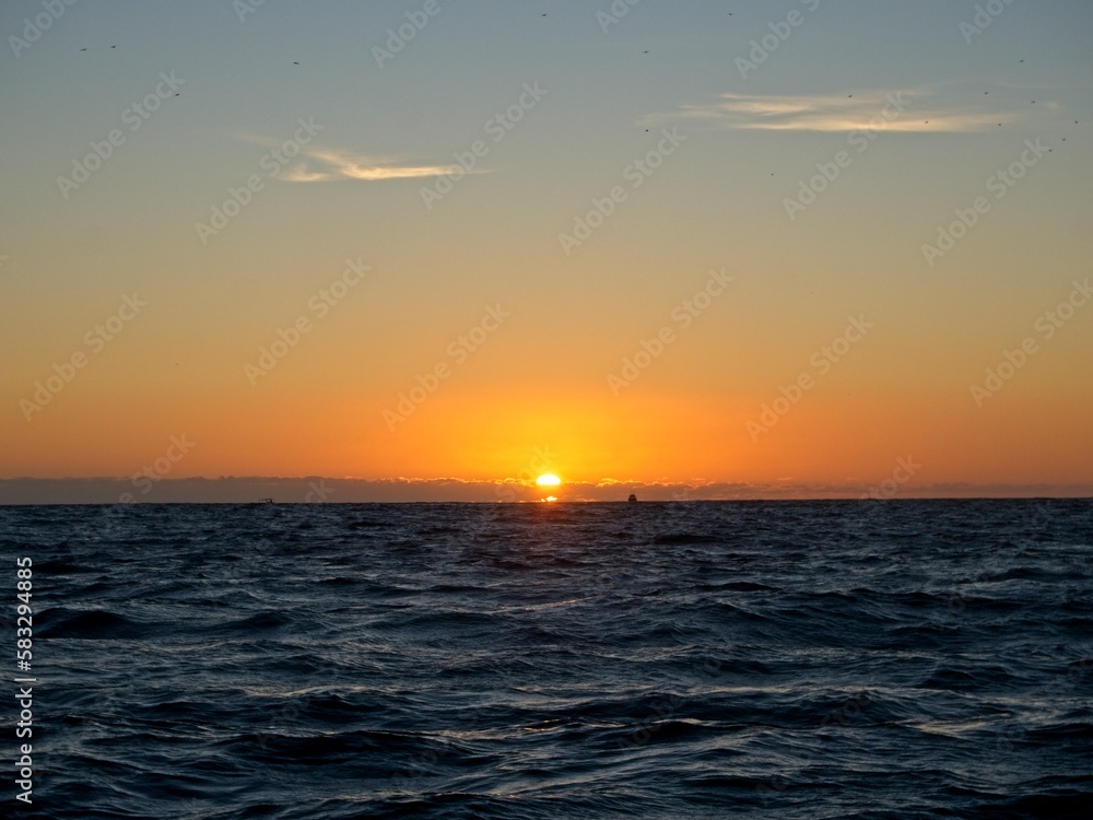 The sun sets over the Pacific Ocean as we sail around the end of the Baja California Peninsula near Cabo San Lucas The sun sets over the Pacific Ocean as we sail around the end of the Baja California Peninsula near Cabo San Lucas