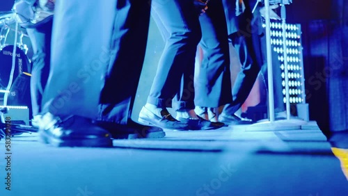 Band feet dancing rhythmically on stage at wedding party
