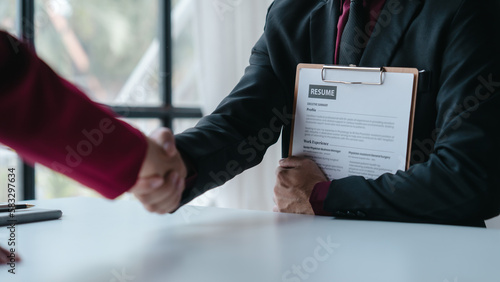 Foto Shaking hands, Close up view of job interview with applicant with resume paper in office, Recruitment, Job application concept