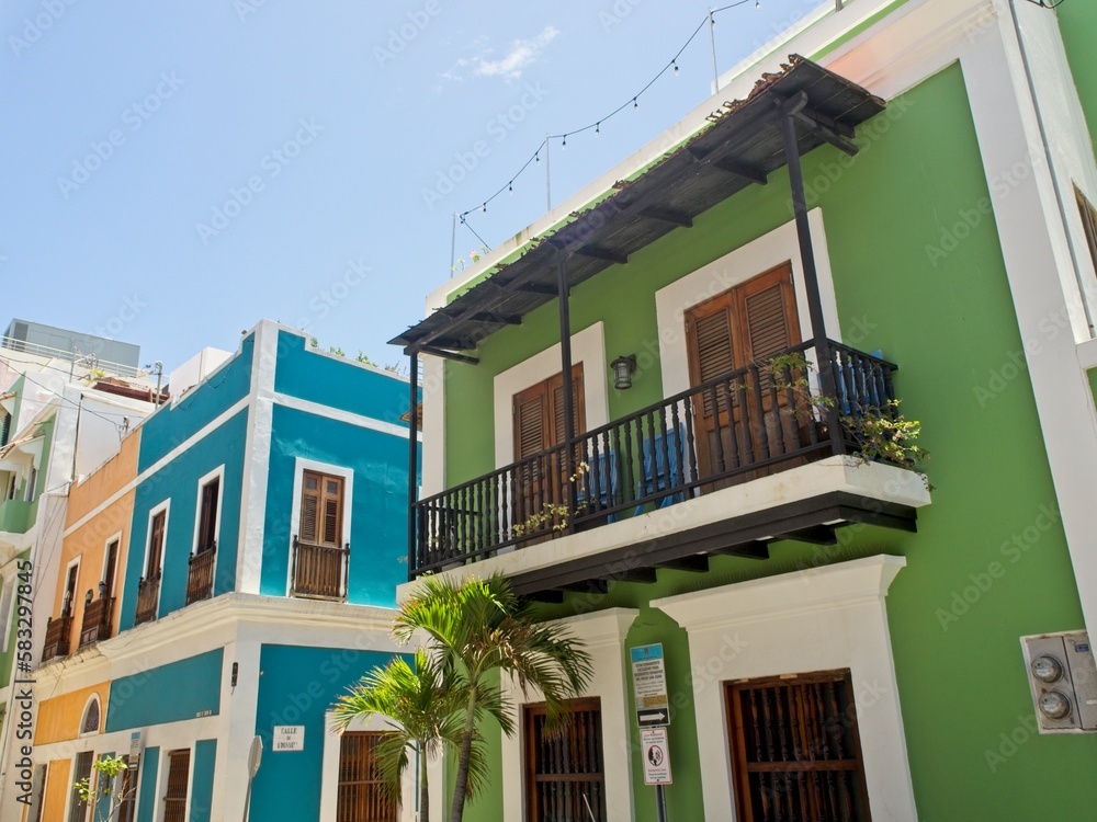 Fototapeta premium Colorful buildings line the cobblestone streets of Old San Juan