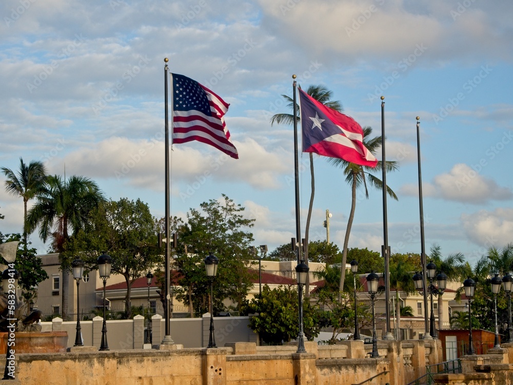 The Puerto Rican Flag and the US Stars and Stripes fly at the waterfront of Old San Juan The Puerto Rican Flag and the US Stars and Stripes fly at the waterfront of Old San Juan
