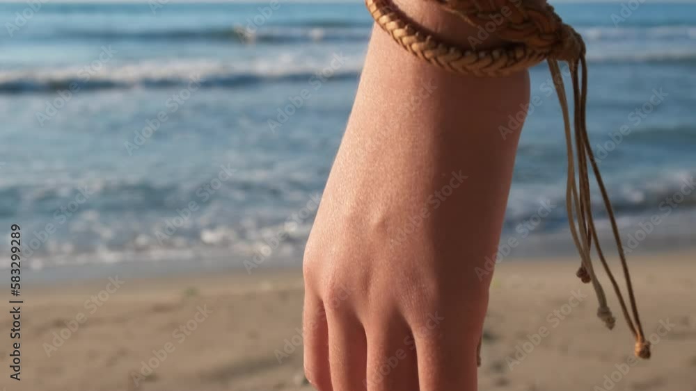 Video Stock Wear friendship bracelet. A young girl wearing friendship