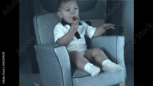 Baby Kazoo 1955 - A baby boy plays with a Kazoo in the 1950s photo