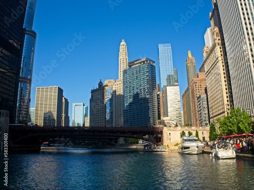 Towering skyscrapers form a canyon of glass buildings lining the Chicago River