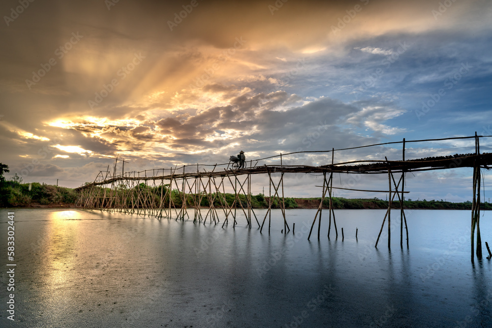 Farmers go to work on a bridge made of bamboo at Cam Dong village, Quang Nam province, Vietnam