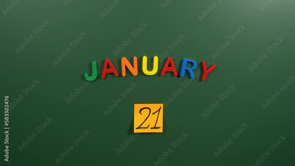 Hand sticking a sticker 21 January calendar day on school board. 21 date of January. Twenty first day of January. 21th date number. 21 day calendar. Twenty one date Hand sticking a sticker 21 January calendar day on school board. 21 date of January. Twenty first day of January. 21th date number. 21 day calendar. Twenty one date