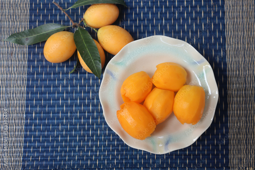 Fresh Peeled Sweet Yellow Marian Plum Fruit or Plum Mango. (Ma Yong Chid in Thai language) Sweet and sour fruit from Thailand. Fresh Peeled Sweet Yellow Marian Plum Fruit or Plum Mango. (Ma Yong Chid in Thai language) Sweet and sour fruit from Thailand.