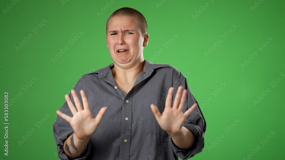 Pretty gender fluid non binary woman 20s pointing fingers herself ask say who me no thanks i do not need it. Portrait isolated on green screen background in studio. Pretty gender fluid non binary woman 20s pointing fingers herself ask say who me no thanks i do not need it. Portrait isolated on green screen background in studio.