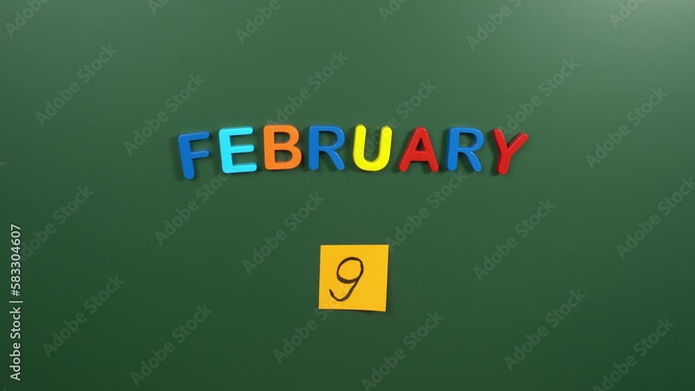 Hand sticking a sticker 9 February calendar day on school board. 9 date of February. Ninth day of February. 9th date number. 9 day calendar. Nine date Hand sticking a sticker 9 February calendar day on school board. 9 date of February. Ninth day of February. 9th date number. 9 day calendar. Nine date