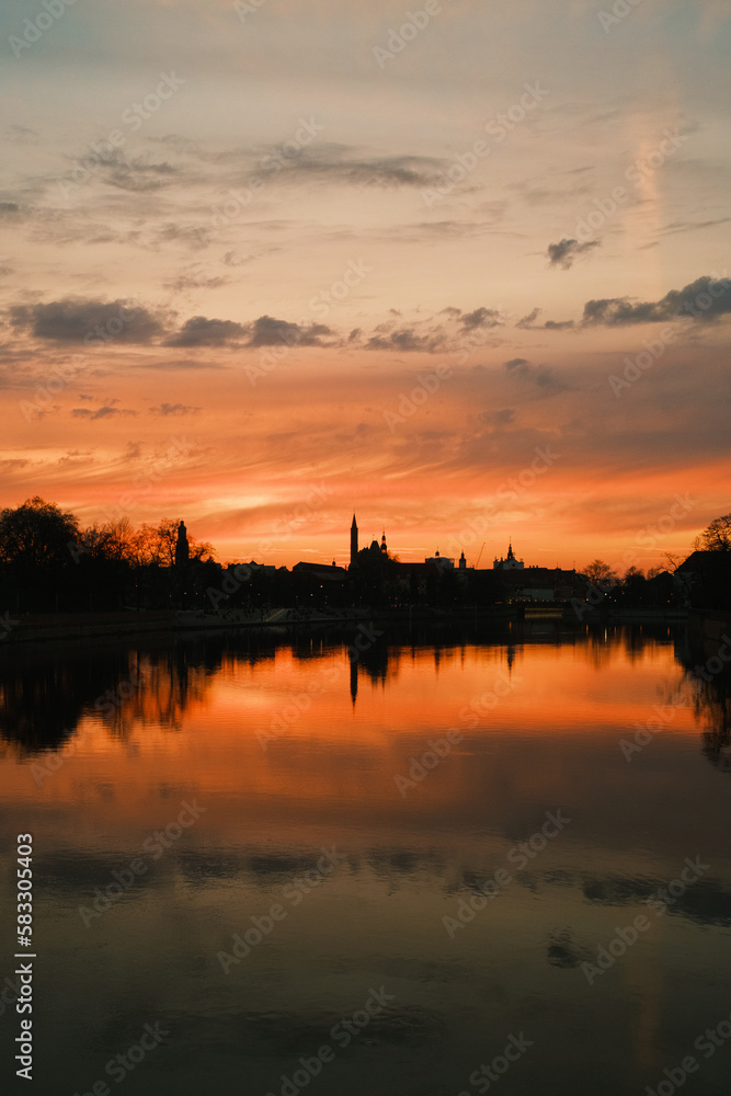 Sunset over the river. Dramatic clouds on the sky. Wrocław, Poland