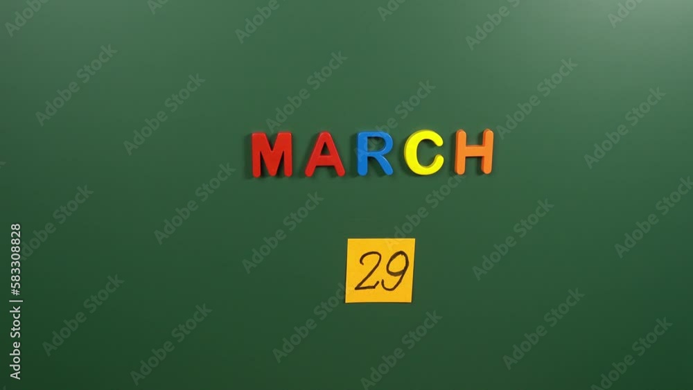 Hand sticking a sticker 29 March calendar day on school board. 29 date of March. Twenty ninth day of March. 29th date number. 29 day calendar. Twenty nine date. Vietnam War Veterans Hand sticking a sticker 29 March calendar day on school board. 29 date of March. Twenty ninth day of March. 29th date number. 29 day calendar. Twenty nine date. Vietnam War Veterans