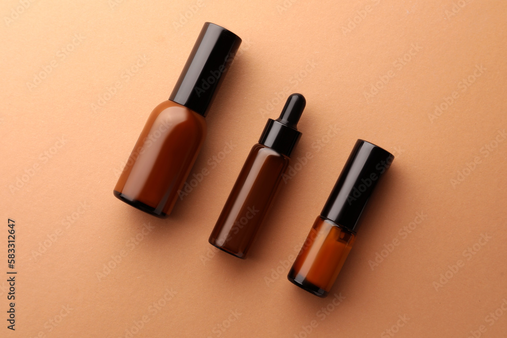 Obraz premium Bottles of face cream on beige background, flat lay