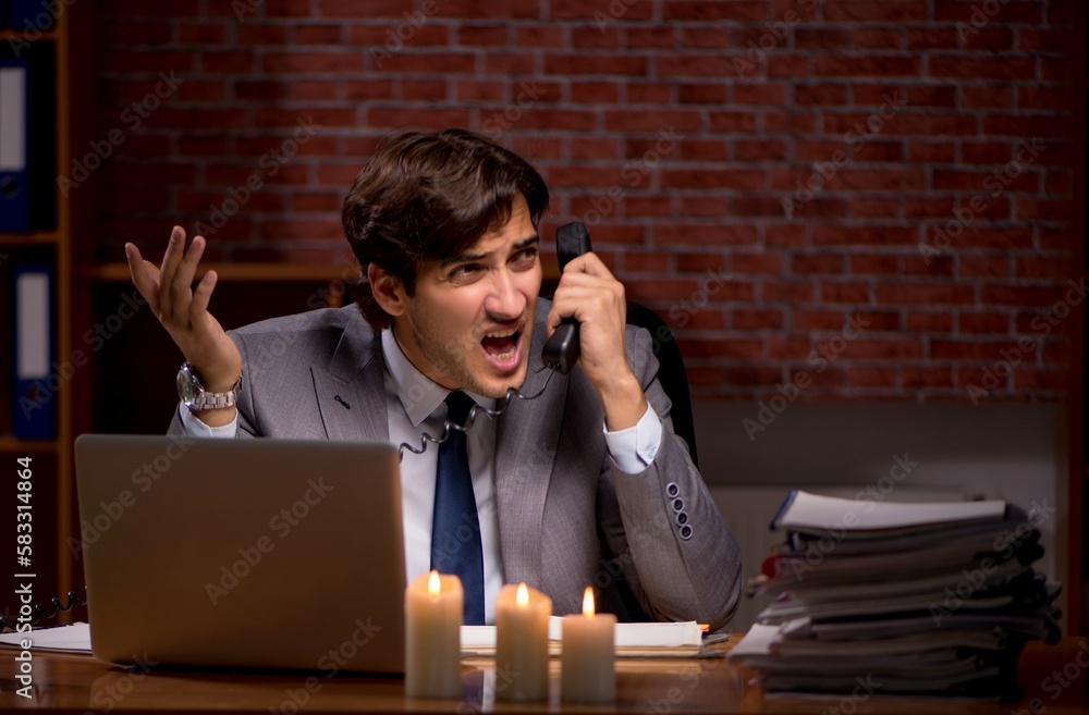 Businessman working late in office with candle light Businessman working late in office with candle light