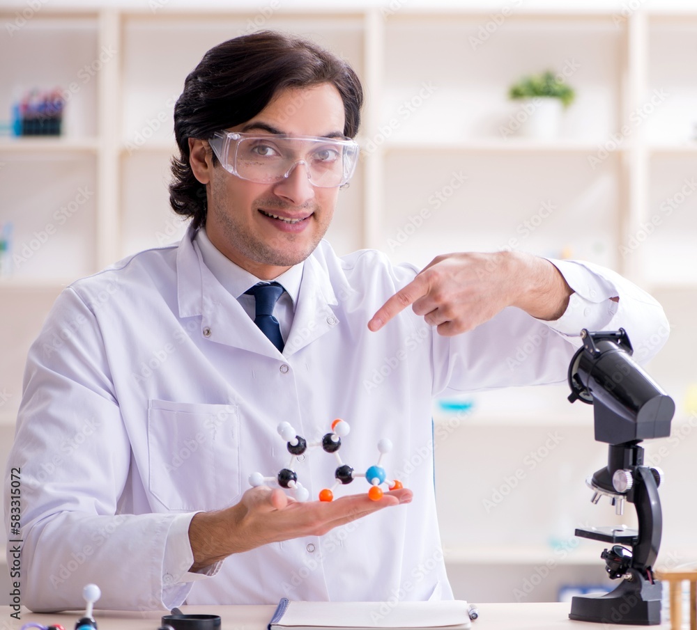 Young male scientist working in the lab Young male scientist working in the lab